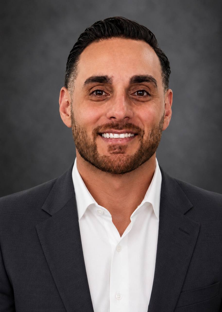 Portrait of Ayman Marji in a suit.